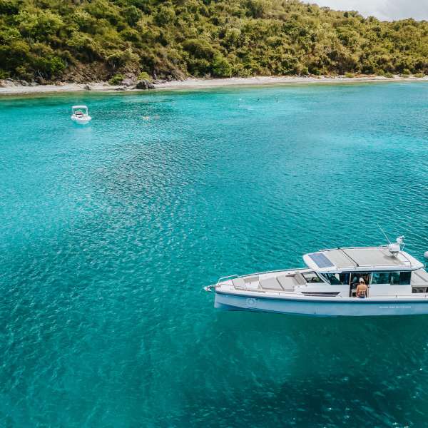 a blue and white boat floating on a body of water